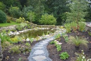 Completed reservoir with planting and stepping stone pathway