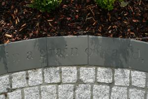 Polished slate paving has been engraved with quote that the client chose.