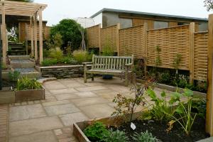 The entrance patio with the beautiful oak hurdle panels giving privacy and provi
